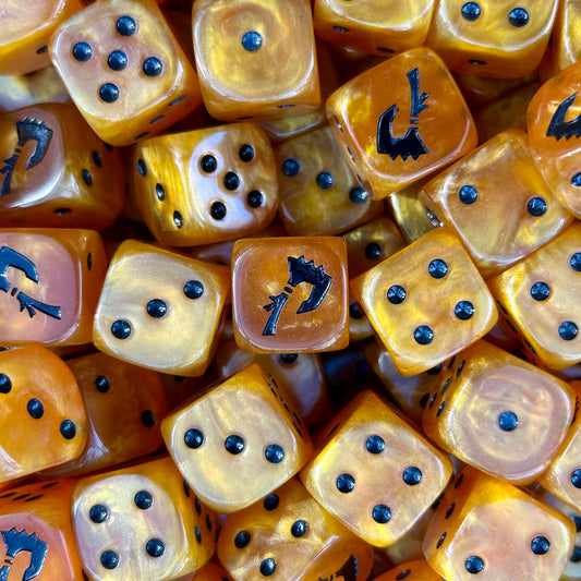 Mighty Melee Games gold event dice with black pips and branded symbols.